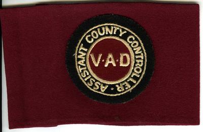 Maroon-coloured brassard with cloth badge: VAD: Assistant County Controller
