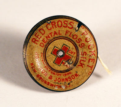 Red Cross "Pocket" Dental Floss Silk dispenser produced by Johnson & Johnson.