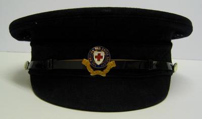 peaked cap, male, with white cap cover and officer's cap badge.