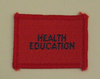 Plain red cloth badge for Youth uniform 'Health Education'.