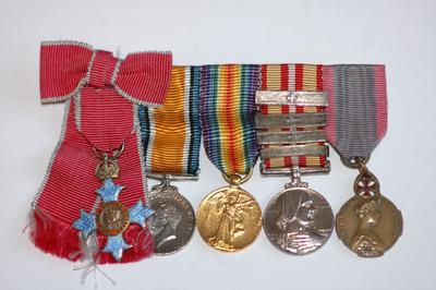Miniature medal bar: MBE, British War Medal, Victory Medal, Voluntary Medical Services medal with 4 bars, and the Queen Elisabeth of Belgium Medal.