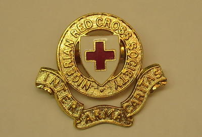 Nigerian Red Cross Society hat badge, made by JR Gaunt, Birmingham.