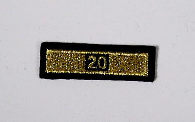 Service award consisting of a gold stripe with '20' incorporated in the design: 20 Years Service.