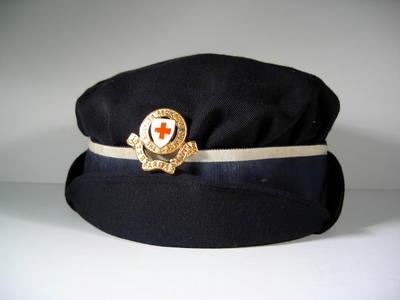 ladies gabardine cap with gilt hat badge and ribbon