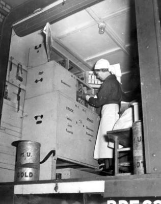 A British Red Cross VAD checking supplies in mobile first aid unit