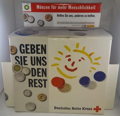 Large cardboard collecting box: 'Munzen fur mehr Menschlichkeit'