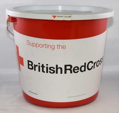 Red plastic British Red Cross collecting bucket