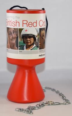 Red plastic British Red Cross collecting box with security chain and handle