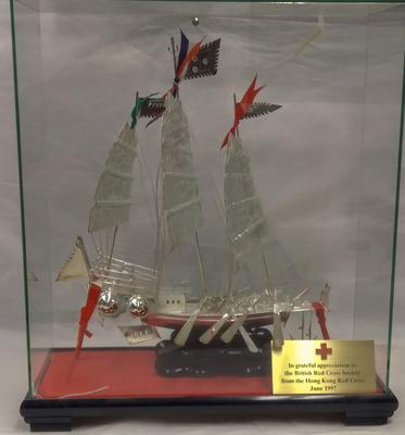 Silver model of a boat in a presentation box gifted by Hong Kong Red Cross, 1997