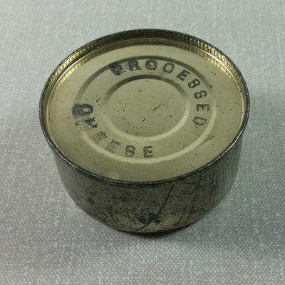 Empty tin with 'Processed cheeese' stamped on top'