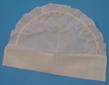 white starched cotton cap with fringes.