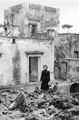 Red Cross member standing in front of ruins after Vesuvius eruption