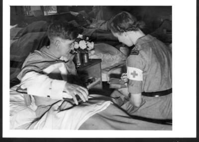 Private David Jones dictates a letter home from Italy to Red Cross Welfare Officer