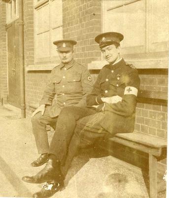 E Hugh Hudson in British Red Cross uniform with brassard and one other man wearing [RAMC] uniform