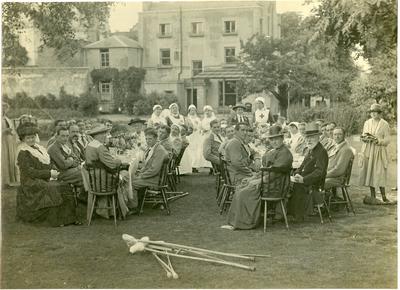 Mayor, Sir A D Dawnay, and Mayoress of Wandsworth and Lady [Heusley] at tea party in garden with VADs and patients