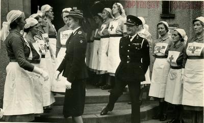 A Female Red Cross Officer wearing Outdoor Uniform inspecting Lines of VADs from the Farnham Division, Surrey