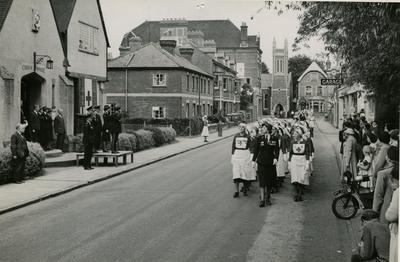 Group of VADs from Farnham Division, Surrey, marching past a Church