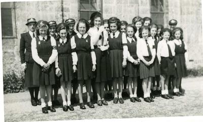 Group of Junior Red Cross girls with senior British Red Cross personnel