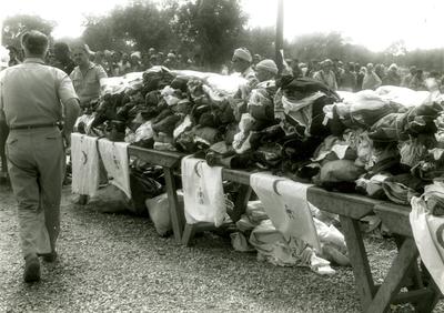 Black and white photograph showing clothes being distributed by the Red Crescent in camp II following the earthquake in March 1960.