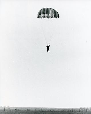 Black and white photograph used in Red Cross News of a Cheshire branch volunteer doing a parachute jump
