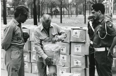 Black and white photograph of the visit and distribution of relief parcels to Pakistani POW's in India from the Pakistani Red Crescent Society