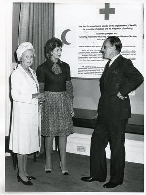 Black and white photograph of Princess Alexandra presenting the Certificate and Badge of Honour Class I to Mrs Boyle, President of Hertfordshire branch, and Mr E W Grazebrook a member of the BRCS Finance Committee