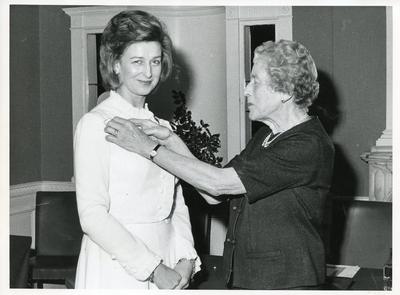 Black and white photograph of the Countess of Limerick awarding HRH Princess Alexandra with the Class I Certificate of Honour and badge