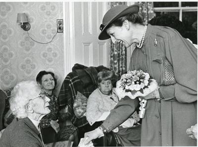 Black and white photograph of Princess Alexandra visiting a retirement home