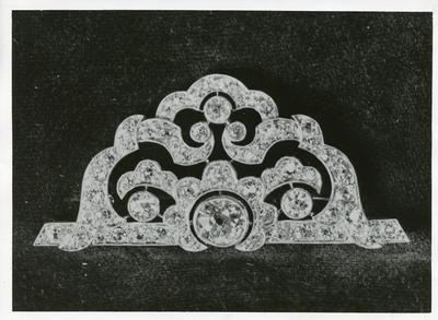 Black and white photograph of a diamond brooch presented to Dame Beryl Oliver by HM The Queen after thirty six years service to the British Red Cross