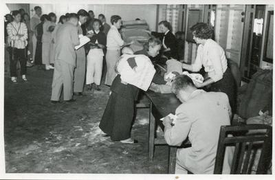Black and white photograph of distributing relief clothing in Hong Kong