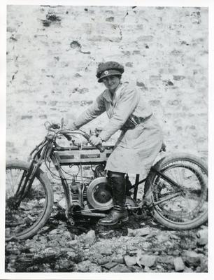 Black and white photograph featuring a female Red Cross despatch rider