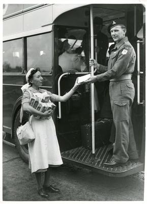 Black and white photograph of a VAD welcoming a soldier home from Korea