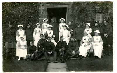 V.A.D.s, hospital nurses and patients posing in front of Dalston Hall Auxilliary Hospital, Dalston, Cumberland.