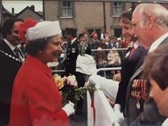 Ann Humphreys, a longstanding British Red Cross volunteer, meeting Her Majesty Queen Elizabeth II in 1986 during a royal visit to her hometown Machynlleth in Wales.
