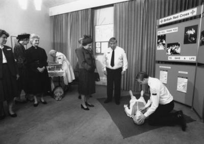 Her Majesty Queen Elizabeth II watching a first aid demonstration at the British Red Cross headquarters.