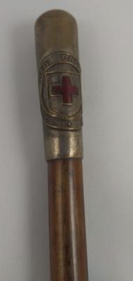 Wooden cane with metal ferrule displaying British Red Cross Society emblem