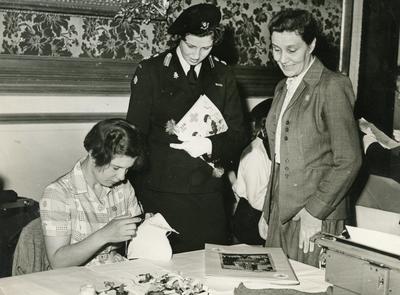 Photograph of a Young Girl demonstrating her work to Princess Alexandra; RCB/2/39/6/30