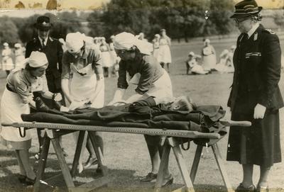 Dame Beryl Oliver watching a First Aid Demonstration at a Rally; RCB/2/58/3/7
