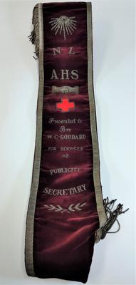 Embroidered velvet sash with Red Cross emblem and trimmed with silver braid