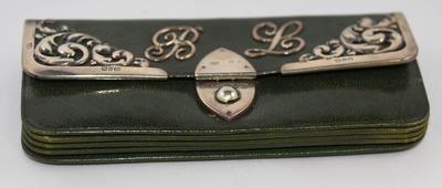 Green leather purse with the initials B.L.