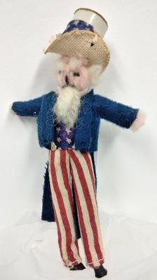 Small woollen doll dressed as Uncle Sam