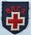 British Red Cross cloth badge: navy shield shape with embroidered emblem and letters British Red Cross