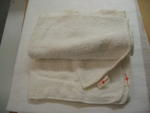 4 nappies with sewn on labels: Gift of the Canadian Junior Red Cross