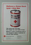 Large poster with an image of a collecting tin: 'The more you can give, the longer we can make it last. For more information, please contact British Red Cross North Wales Branch.'