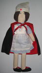 Rag doll in Red Cross nurses uniform with cape