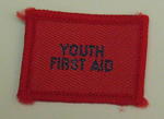 Plain red cloth badge for Youth uniform 'Youth First Aid'.