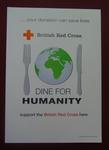 white poster featuring a knife and fork surrounding a globe with the words, 'Dine for Humanity'