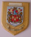 Brass and wooden shield featuring the badge of Lancashire County Council presented to Countess Limerick on the 11th July 1991