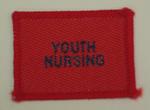 Red cloth flash, to be worn on uniform by Red Cross Youth who holds a certificate in Youth Nursing. With the words 'Youth Nursing' in white.