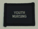 Navy blue cloth flash, to be worn on uniform by Red Cross Junior who holds a certificate in Youth Nursing. With the words 'Youth Nursing' in white.